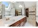 Spacious bathroom with double vanity, skylight, and floral wallpaper at 469 White Heron Ct. Sw, Sunset Beach, NC 28468