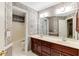 Bathroom with double sinks, vanity, and floral wallpaper at 469 White Heron Ct. Sw, Sunset Beach, NC 28468