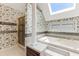 Bright bathroom with a large soaking tub, separate shower, and floral wallpaper at 469 White Heron Ct. Sw, Sunset Beach, NC 28468