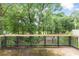 View from a mossy deck into a lush backyard with mature trees at 469 White Heron Ct. Sw, Sunset Beach, NC 28468