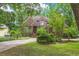 Beautiful brick home with lush landscaping, a circular driveway, and manicured lawn at 469 White Heron Ct. Sw, Sunset Beach, NC 28468