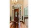 Grand foyer featuring a chandelier, wood floors, and elegant front door at 469 White Heron Ct. Sw, Sunset Beach, NC 28468