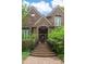 Charming front entrance with brick steps, and lush landscaping at 469 White Heron Ct. Sw, Sunset Beach, NC 28468
