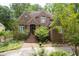 Charming brick home featuring mature trees, landscaped yard, and a welcoming front entrance at 469 White Heron Ct. Sw, Sunset Beach, NC 28468