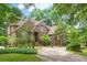 Lovely home with brick exterior, a circular driveway, and lush landscaping at 469 White Heron Ct. Sw, Sunset Beach, NC 28468