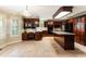 Spacious kitchen boasts dark wood cabinets, granite counters, and an island with bar seating at 469 White Heron Ct. Sw, Sunset Beach, NC 28468