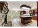 An open-concept kitchen area features an island, tile floors, and a dining nook at 469 White Heron Ct. Sw, Sunset Beach, NC 28468