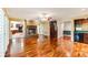 Bright living room with a brick fireplace, hardwood floors, and an open layout at 469 White Heron Ct. Sw, Sunset Beach, NC 28468