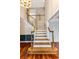 Elegant staircase with wood railing, newel post and hardwood floors at 469 White Heron Ct. Sw, Sunset Beach, NC 28468