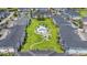 Aerial view of condo community featuring a central pool, landscaped lawns, lush landscaping, and manicured walkways at 4846 Carnation Circle # 301, Myrtle Beach, SC 29577