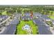 Aerial view of condo community with a central pool, lush green spaces, manicured lawns, and ample parking at 4846 Carnation Circle # 301, Myrtle Beach, SC 29577