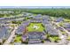 Aerial view of condos with a central green space, swimming pool, golf course, and lush landscaping at 4846 Carnation Circle # 301, Myrtle Beach, SC 29577