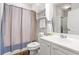 Well-lit bathroom with updated sink and shower-tub combination with blue shower curtain at 4846 Carnation Circle # 301, Myrtle Beach, SC 29577