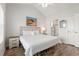 Comfortable bedroom adjacent to en-suite bathroom, featuring a king bed and beach themed decor at 4846 Carnation Circle # 301, Myrtle Beach, SC 29577