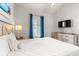 Bright bedroom with modern furnishings, a television and a comfortable king-size bed at 4846 Carnation Circle # 301, Myrtle Beach, SC 29577