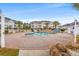 A pristine community pool is surrounded by well-manicured landscaping and inviting residences, ideal for relaxation and recreation at 4846 Carnation Circle # 301, Myrtle Beach, SC 29577