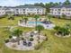 This aerial view showcases a pool and grilling area surrounded by beautiful landscaping and well-maintained condo buildings at 4846 Carnation Circle # 301, Myrtle Beach, SC 29577