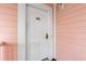 Close up of a white door with the number 301 on a pink exterior wall at 4846 Carnation Circle # 301, Myrtle Beach, SC 29577