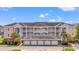 A beautiful multi-story pink condo building with white trim, balconies, and palm trees at 4846 Carnation Circle # 301, Myrtle Beach, SC 29577