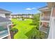 Beautiful view of the condo buildings and a lush green lawn with a white picket fence and a pool at 4846 Carnation Circle # 301, Myrtle Beach, SC 29577