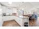 Bright, open kitchen featuring white cabinets, granite countertops, and wood-look flooring at 4846 Carnation Circle # 301, Myrtle Beach, SC 29577