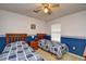 Bedroom featuring two twin beds, a ceiling fan, and blue-and-white accents at 5050 Windsor Green Way # 203, Myrtle Beach, SC 29579