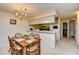 Cozy dining area with wooden table, chandelier lighting, and easy access to the kitchen at 5050 Windsor Green Way # 203, Myrtle Beach, SC 29579