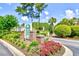 The main entrance sign with colorful landscaping at 5050 Windsor Green Way # 203, Myrtle Beach, SC 29579