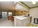 Open kitchen view featuring stainless steel appliances, breakfast bar, and adjacent dining and living spaces at 5050 Windsor Green Way # 203, Myrtle Beach, SC 29579