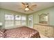 Bright main bedroom featuring a dresser and a large window with blinds at 5050 Windsor Green Way # 203, Myrtle Beach, SC 29579