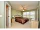 Tranquil main bedroom with a ceiling fan, ensuite door, and natural light from the window at 5050 Windsor Green Way # 203, Myrtle Beach, SC 29579
