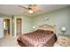 Main bedroom featuring a ceiling fan, walk-in closet, and neutral carpeting at 5050 Windsor Green Way # 203, Myrtle Beach, SC 29579
