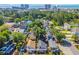 Aerial view of a neighborhood with lush greenery, colorful houses, and a cityscape in the background at 510 Rosemary Ln., North Myrtle Beach, SC 29582