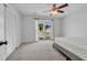 Bright bedroom with balcony access, ceiling fan, and a closet at 510 Rosemary Ln., North Myrtle Beach, SC 29582