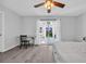 Sunlit bedroom with a ceiling fan, desk, and sliding glass door access to a patio at 510 Rosemary Ln., North Myrtle Beach, SC 29582