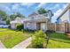 Charming exterior of a two-story home showcasing a white picket fence and well-manicured lawn at 510 Rosemary Ln., North Myrtle Beach, SC 29582