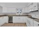 Well-lit kitchen features white cabinets, updated appliances, and a sink with a view at 510 Rosemary Ln., North Myrtle Beach, SC 29582