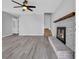 Open-concept living room features a gray brick fireplace and modern ceiling fan at 510 Rosemary Ln., North Myrtle Beach, SC 29582