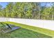 Backyard view, including privacy fence, lounge chairs, green grass, and shade at 520 Cattle Drive Circle, Myrtle Beach, SC 29588