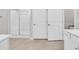 Bathroom showing shower and door frame with bright white cabinets and counters at 520 Cattle Drive Circle, Myrtle Beach, SC 29588