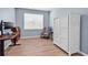 Bedroom with wood floors, blue walls, a large white cabinet and a window at 520 Cattle Drive Circle, Myrtle Beach, SC 29588