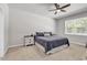 Cozy bedroom features plush carpeting, a ceiling fan, and a comfortable bed and nightstand at 520 Cattle Drive Circle, Myrtle Beach, SC 29588