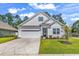Charming single-Gathering home with a well-manicured lawn, two-car garage, and welcoming front entrance at 520 Cattle Drive Circle, Myrtle Beach, SC 29588