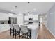 Bright kitchen featuring a center island with seating, white cabinets, and stainless steel appliances at 520 Cattle Drive Circle, Myrtle Beach, SC 29588