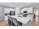 Beautiful kitchen with white cabinets, stainless steel appliances, and a spacious center island with barstool seating at 520 Cattle Drive Circle, Myrtle Beach, SC 29588