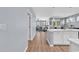 Open-concept view to the Kitchen featuring a large island with an eat-in bar, opening to the Living Room at 520 Cattle Drive Circle, Myrtle Beach, SC 29588