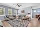 Bright living room with large windows, wood floors, and a seamless flow into the dining area at 520 Cattle Drive Circle, Myrtle Beach, SC 29588