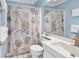 Cozy bathroom featuring coastal-themed shower curtain, white sink, and blue walls at 5601 N Ocean Blvd. # B316, Myrtle Beach, SC 29577