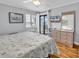 Cozy bedroom with light grey walls, a queen bed, and balcony access with natural light at 5601 N Ocean Blvd. # B316, Myrtle Beach, SC 29577
