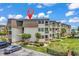 Exterior view of condo building with multiple balconies, landscaping, and ample parking space at 5601 N Ocean Blvd. # B316, Myrtle Beach, SC 29577